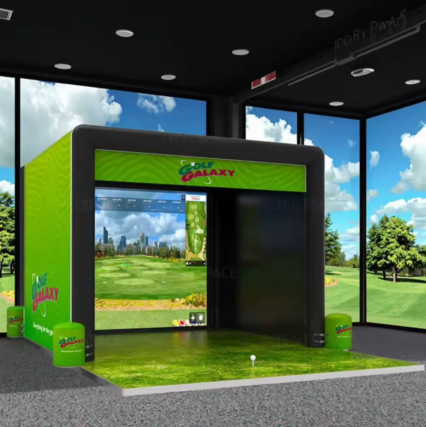 Interior view of inflatable golf simulator showing digital course projection and green turf flooring.